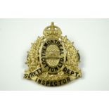 A gilt metal and enamel cap badge for "The Montreal Cotton Ltd Surety Department Inspector",