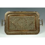 A 19th century Indian repousse worked two handled copper tea tray, 70 cm