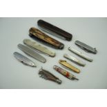 A collection of penknives together with a hoof knife with antler scales