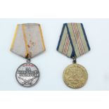 A Soviet Medal for Battle Merit and one other medal