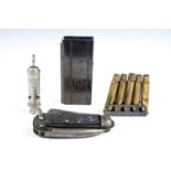 A clip of .303 cartridge cases together with a magazine, a clasp knife and a 1945 British army