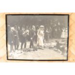 A framed large period photograph of a Royal visit from King George V and Queen Mary, in slender