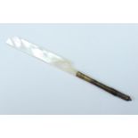 A mother of pearl and brass dip pen, the handle in the form of a feather, early 20th Century, 14.5
