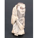 A Japanese stag horn netsuke of Shoki, 6 cm (a/f)