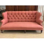 A late Victorian button-upholstered wing back low sofa, 195 cm wide x 85 cm high, seat 65 cm deep