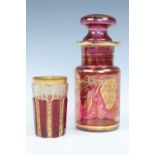A gilt ruby glass toiletry bottle and beaker, bottle 19 cm