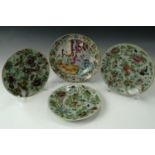 Three 20th Century oriental plates enamelled in depiction of butterflies and birds, together with an