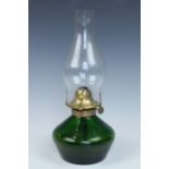 A green glass oil lamp, 33 cm