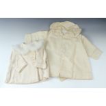 An infant's hand made coat dress, having embroidered cuffs and shawl collar, mid 20th Century, front