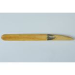 A small late 19th / early 20th Century ivory paper / letter knife, bearing a shield shaped plaque,