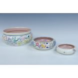 Three Poole hand-painted pots, largest diameter 19 cm