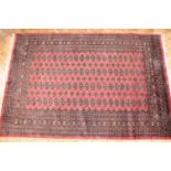 A large wool and silk blend Pakistani Bokhara rug, 280 x 190 cm