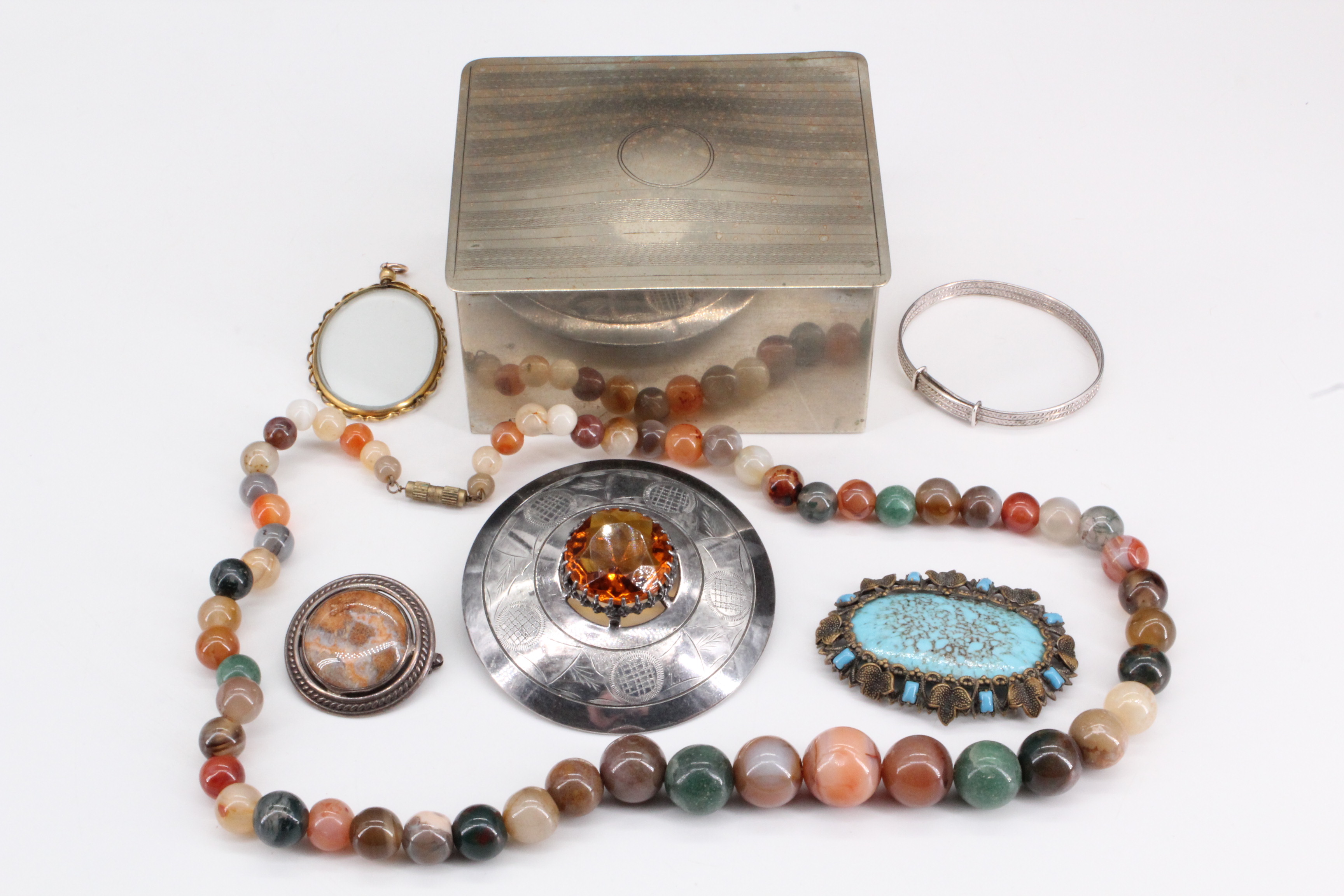 A selection of costume jewellery in an electroplate box, comprising an agate bead necklace, a