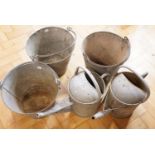 Three vintage galvanized buckets and two traditional watering cans