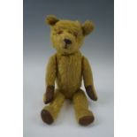 A gold coloured articulated mohair Teddy bear, evidence of a growler, second half 20th Century