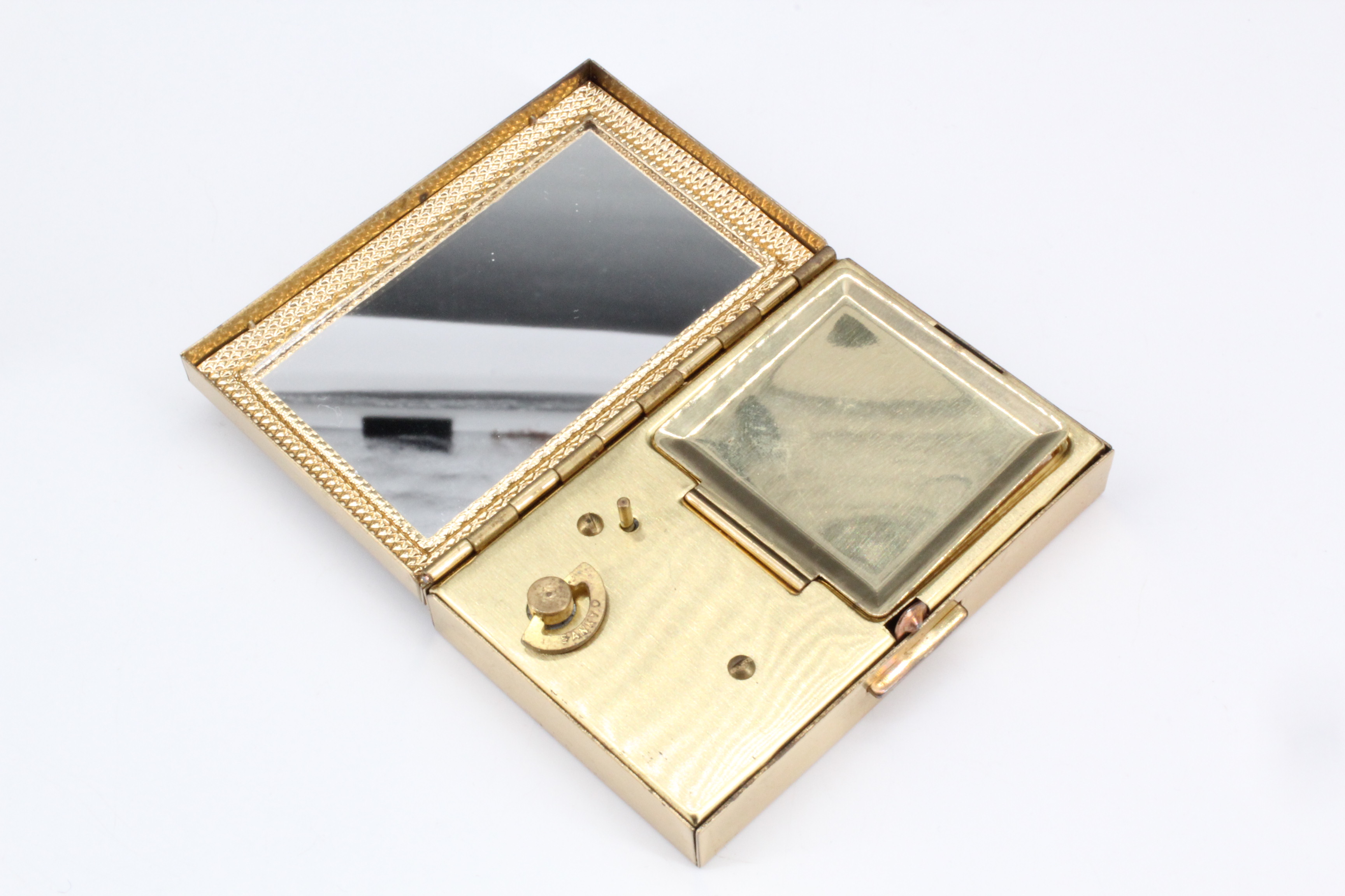 A Japanese musical compact, in its original box and protective cloth case, unused, 7.5 cm x 5 cm x 2 - Image 2 of 3
