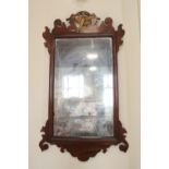 A old reproduction Georgian parcel-gilt mahogany fret mirror having a ho-ho bird crest, 93 cm