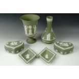 Six items of Wedgwood green Jasperware comprising two vases, two lidded pots and two dishes