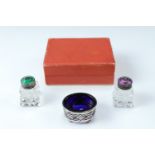 A pair of basse taille enamelled sterling white metal capped salt and pepper pots together with a