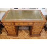 A Victorian oak pedestal desk having inset tooled leather top and Aesthetic influenced brass drop