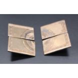 A pair of 1950s cufflinks, formed as four quarters of an engraved geometric design on yellow and