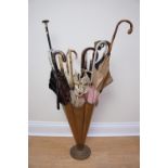 A novelty umbrella and stick stand in the form of an umbrella containing an assortment of vintage