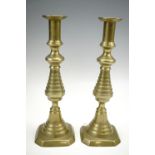 A pair of Victorian push eject brass candle sticks, 31 cm