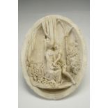 An oval cast plaster plaque depicting medieval lovers, 24 cm