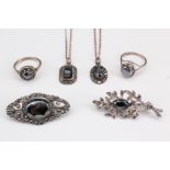A selection of silver and hematite jewellery, comprising two necklaces with pendants of faceted