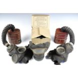 Two Second World War British military General Service respirators together with two Home Front
