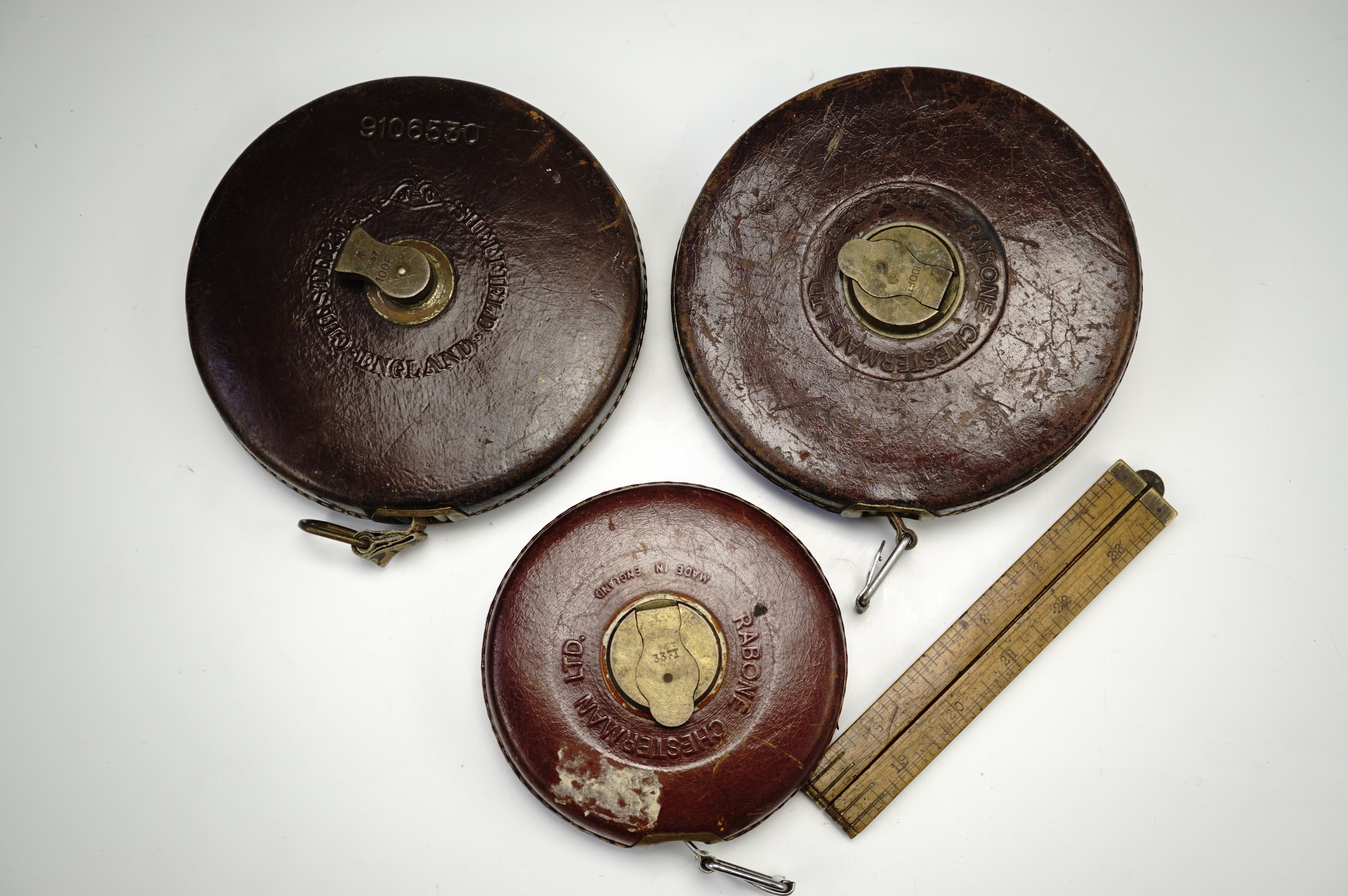 Three architect's / surveyor's tape Rabone measures, imperial markings, one with a repaired end