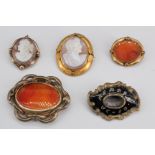 Four Victorian cameo and agate brooches, together with a Victorian gilt metal and black enamel
