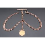 An Edwardian 9 ct gold double Albert watch chain, of graduated curb links on an associated central