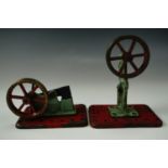 A pair of early 20th Century Mamod accessories for toy steam engines, having brass flywheels,