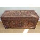 [Tribal art] A carved African hardwood chest, having a top and front carved with kings flanked by