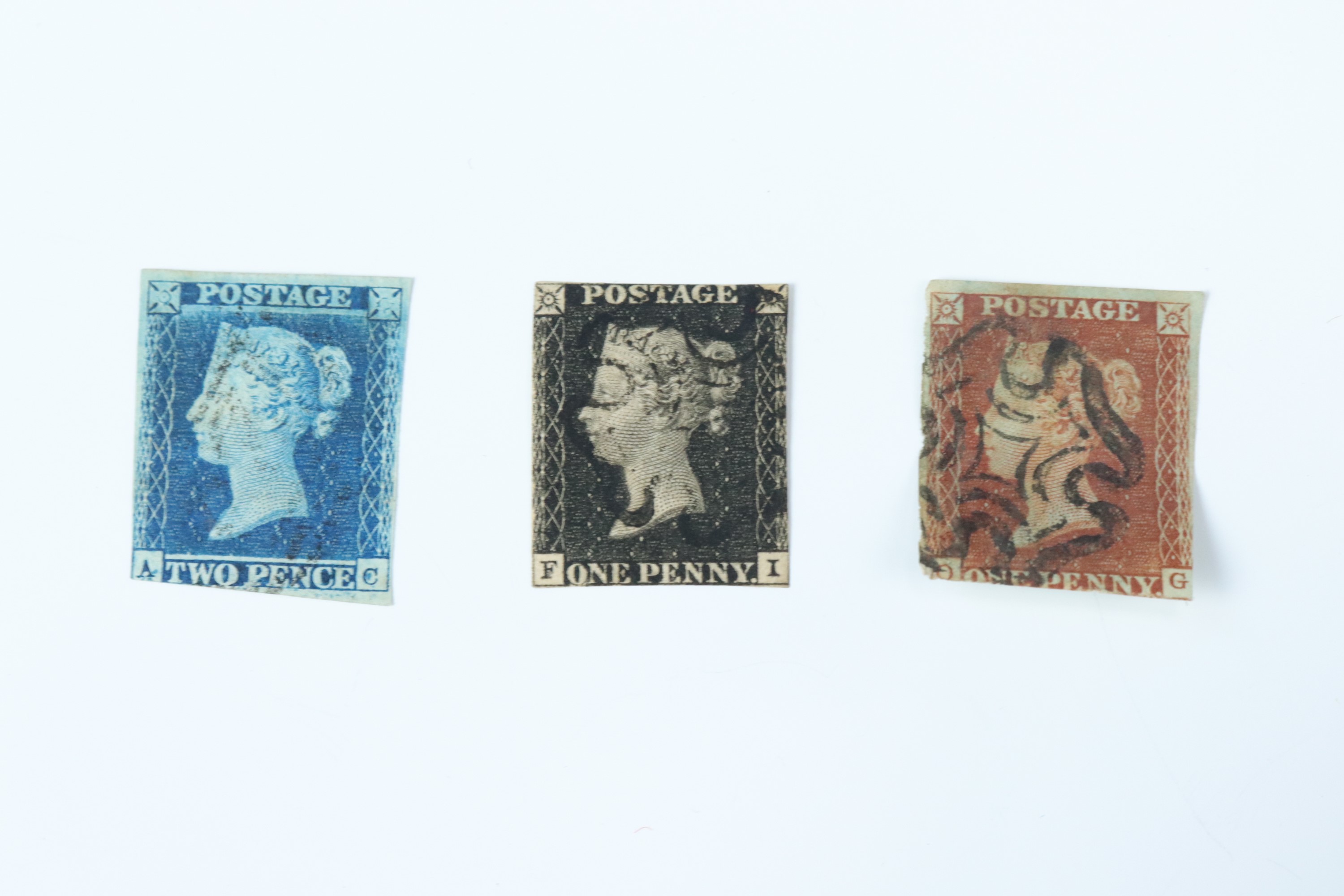 A Penny Black stamp together with a Penny Blue stamp and Penny Reds