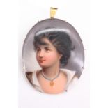 An early 20th Century yellow metal mounted enamelled porcelain pendant brooch, portraying a young
