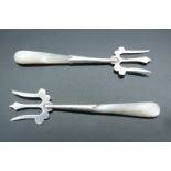 A pair of Edwardian silver pickle forks having mother of pearl handles