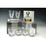 A boxed Dartington "Shuggy Bar" spirit decanter together with boxed Dartington dimple glasses and