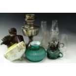 Two green glass finger lamps, two Victorian glass oil lamp bodies, and a chrome plated oil lamp (