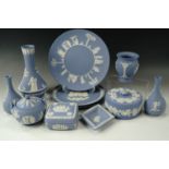 Eleven items of Wedgwood blue Jasperware including four vases, three plates, a pin dish etc
