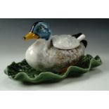 A novelty preserve pot in the form of a duck seated on a leaf, with conforming spoon