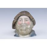 A late 19th Century German ceramic tobacco pot in the form of a fisherman, 13 cm