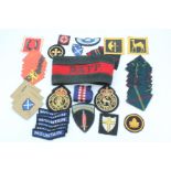A quantity of British military and Civil Defence cloth insignia including an RAF Police brassard