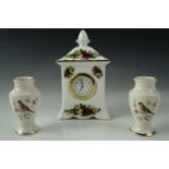 A Royal Albert "Old Country Roses" clock together with a pair of Royal Worcester Palissy "petite