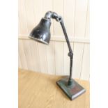 A vintage enamelled workshop adjustable lamp, approximately 75 cm high when upright