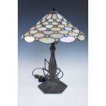 A early 20th Century bronzed table lamp with Tiffany influenced leaded glass shade, 50 cm