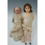 Two Victorian "wax over" dolls with composition limbs and straw bodies, one with fixed glass eyes,