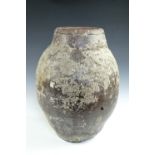 A large barnacle encrusted Chinese salt glazed oviform storage jar bearing an impressed seal mark,