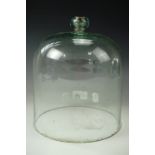 A Victorian green glass cloche or bell jar, having a cork-stopped globular knop 19 cm diameter x